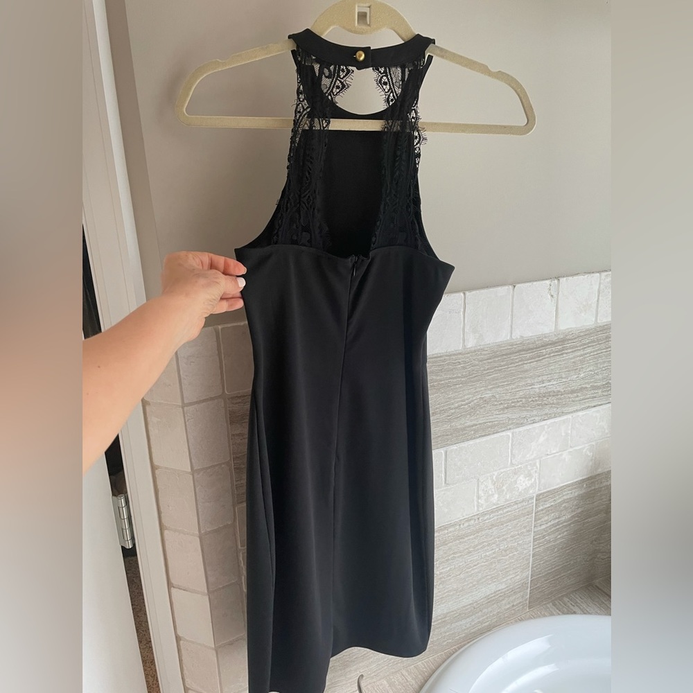 Black fitted mini lace halter back with gold button around the neck. Back zipper